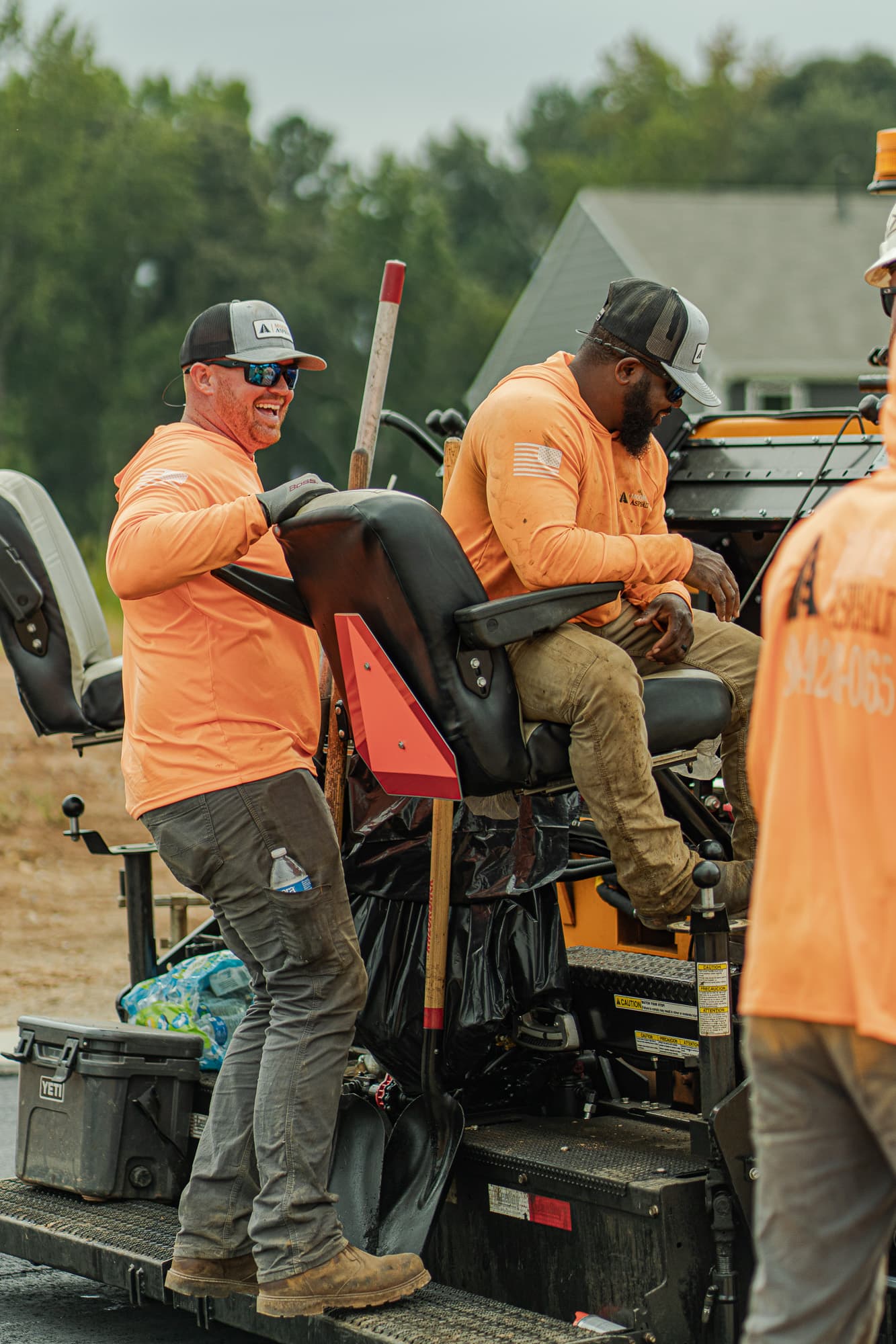 Moore Asphalt crew members on the paving equipment