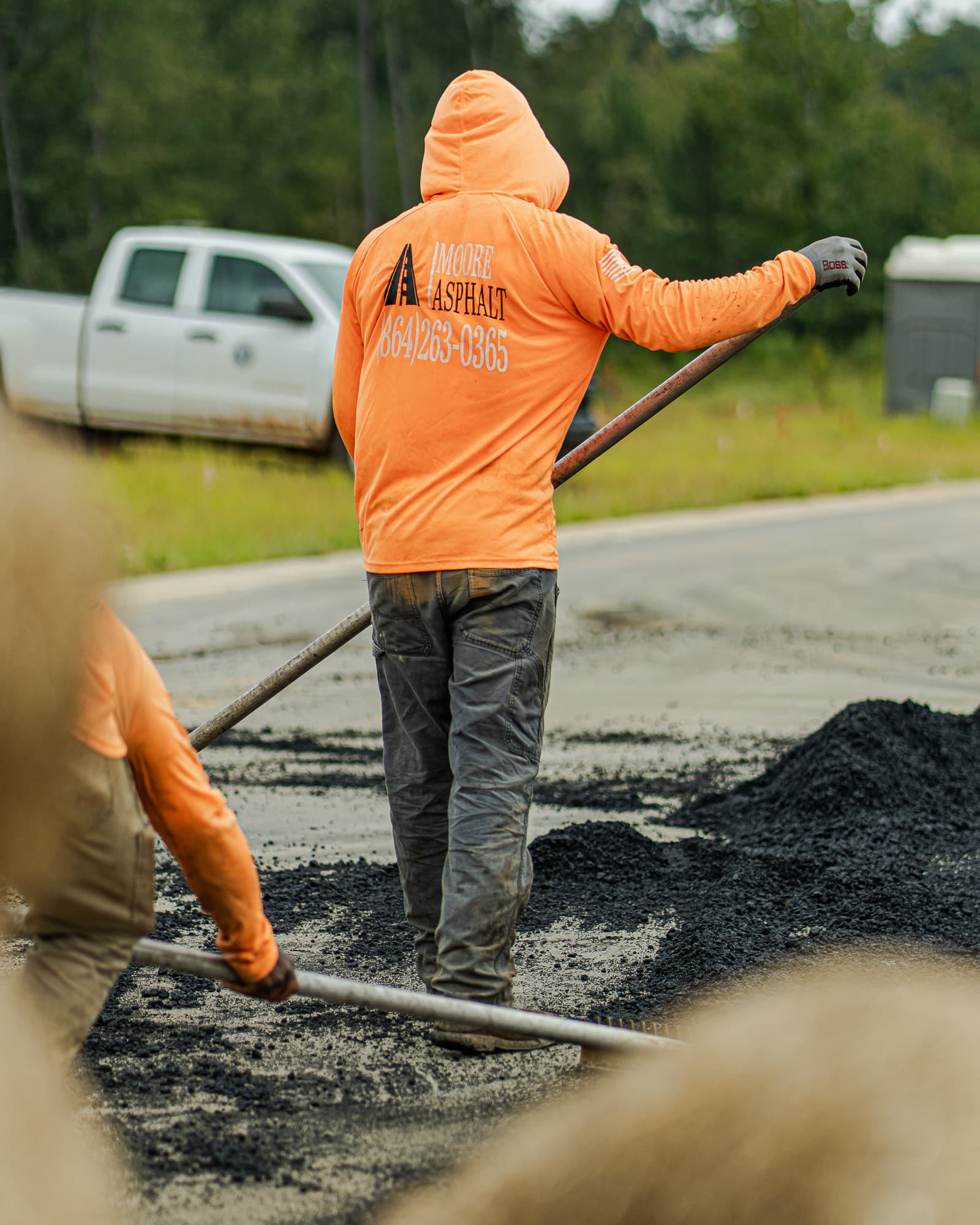 Moore Asphalt crew member working in a branded safety shirt