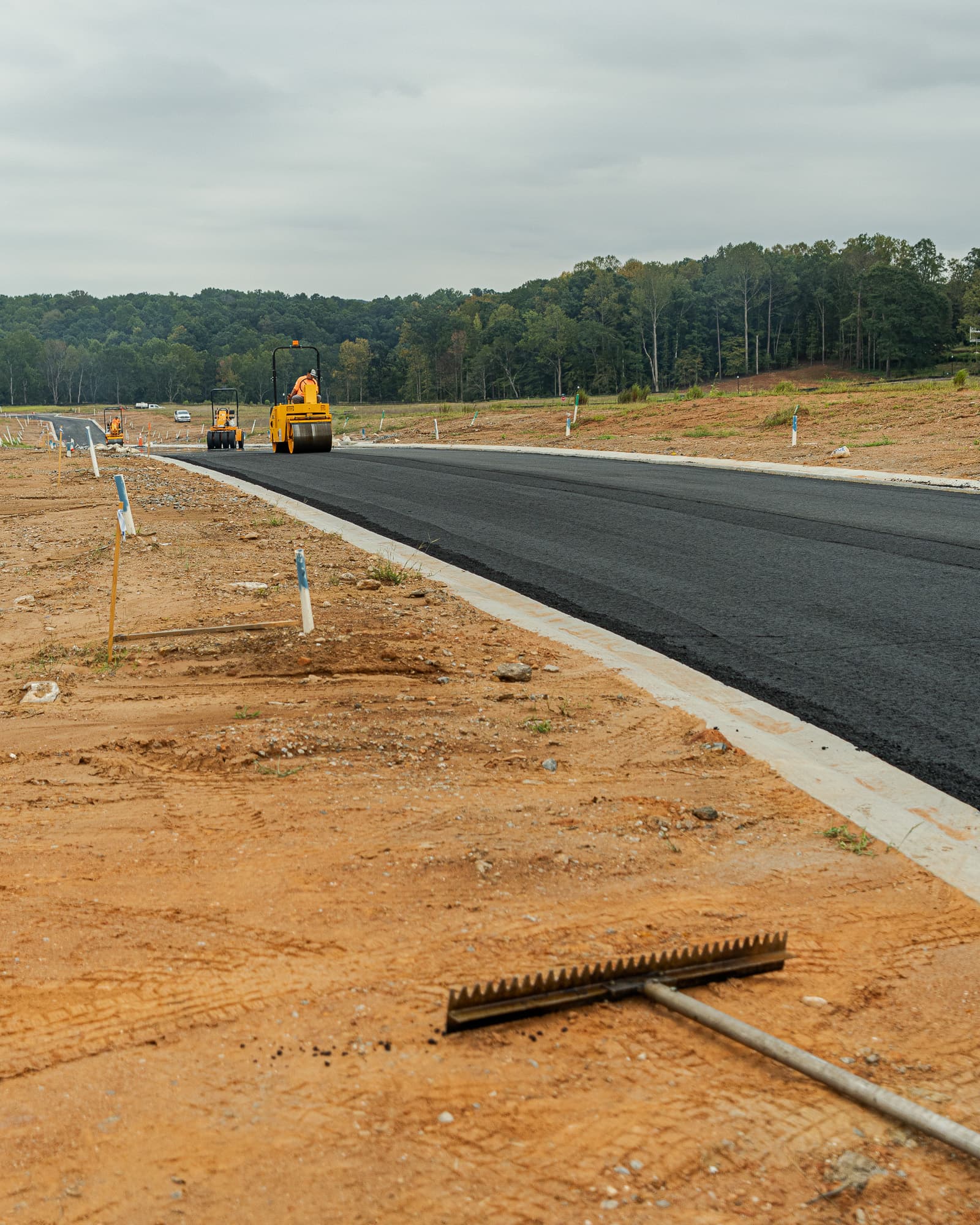 Rollers compacting a newly paved neighborhood road
