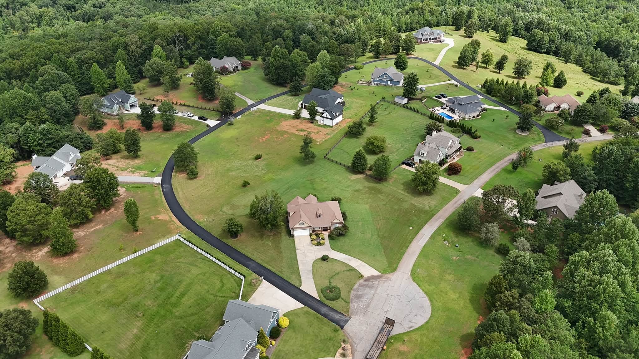 New asphalt road winding through a residential neighborhood